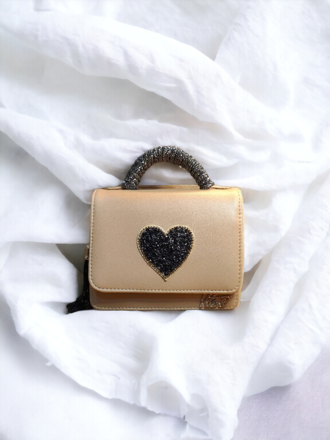 A ladies heart crossbody on a plain white background. 
